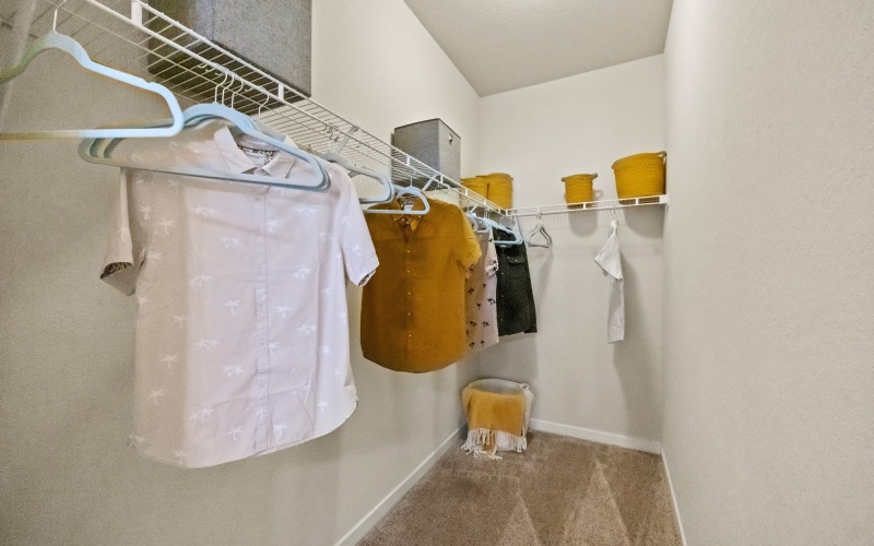 Closet with clothes hanging inside